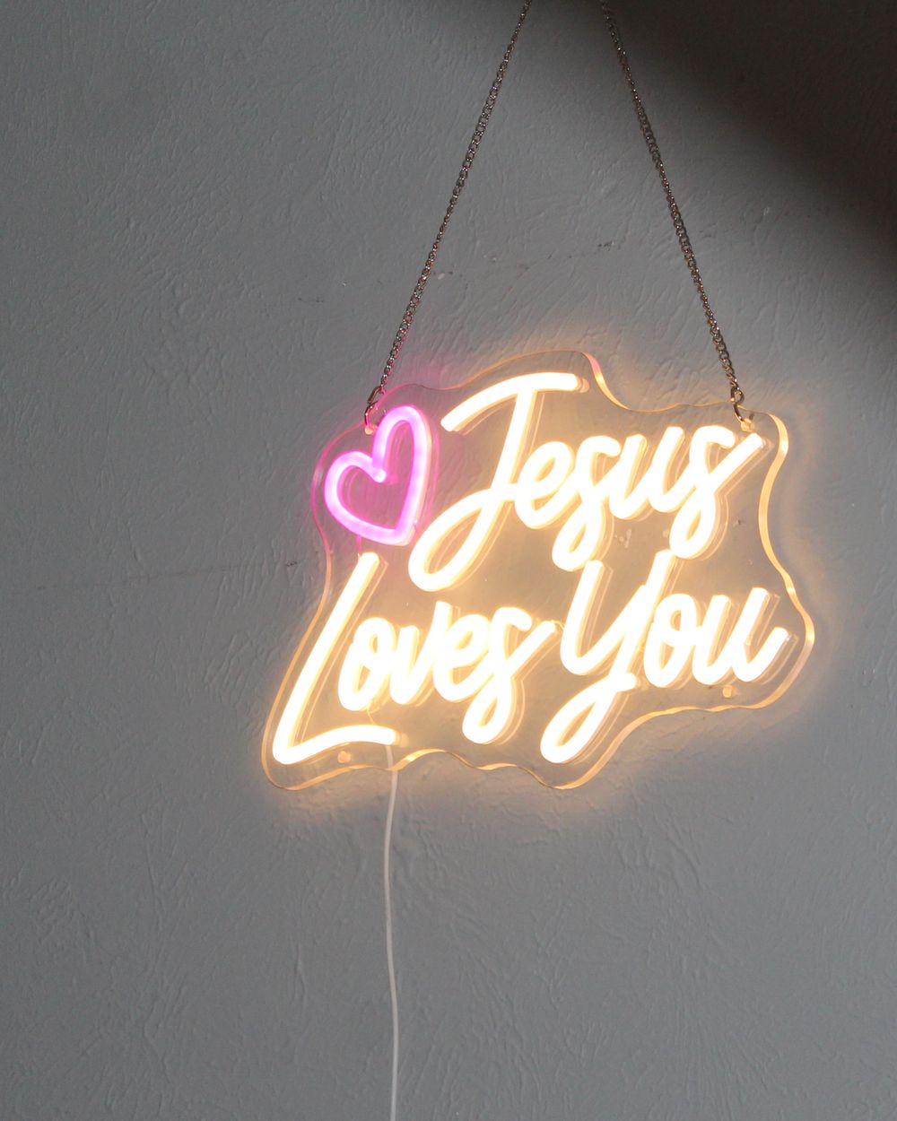 Jesus Loves You neon sign in the studio